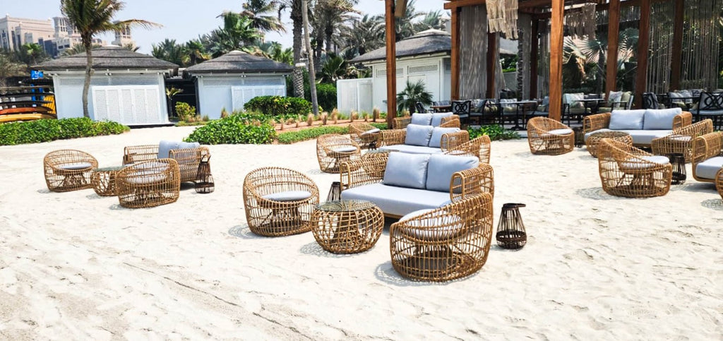 Nest lounge sofa, round chairs and coffee tables at the beach at French Riviera Beach Restaurant