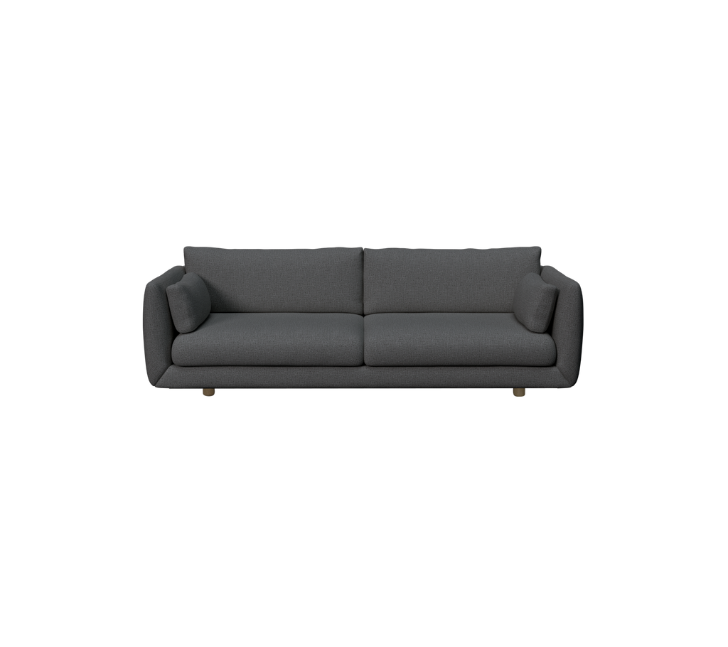 Dunkelgrüne moderne Couch mit weichen Kissen.