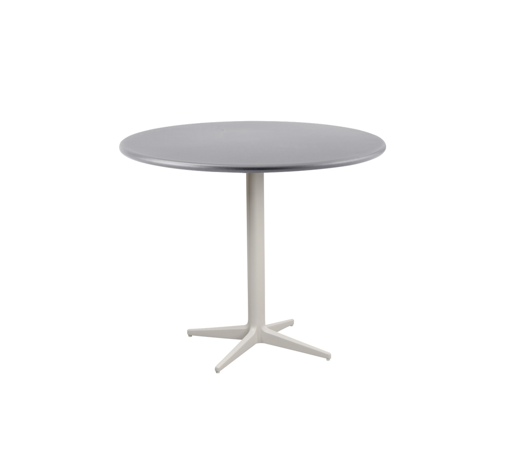Modern runder Tisch mit einer glatten grauen Oberfläche und einem stabilen, hellen Fuß mit einem vierbeinigen Design.