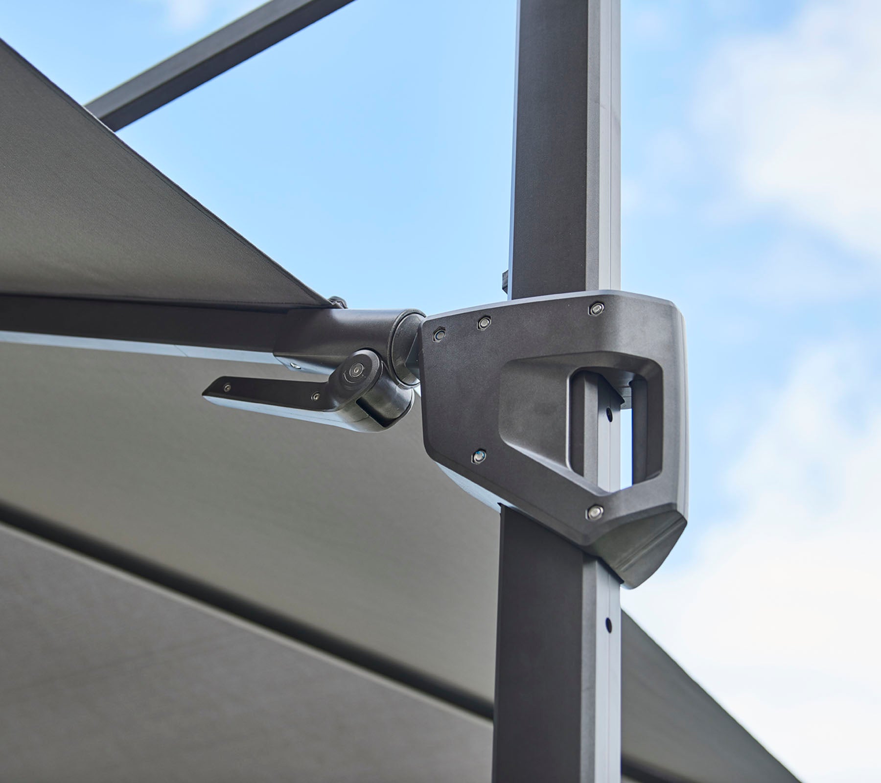 Verstellbare Hardwarebefestigung für eine Schattenstruktur, die ein schlankes metallisches Design und funktionale Mechanik zeigt.